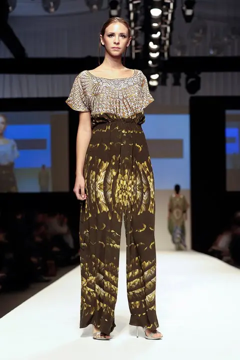 Arabian Nomads : Exclusive Arab Dress Collection at DFW, SS11 7 Flared jumpsuit with crystal-textured upper section and falcon wing print, gathered at the waist.